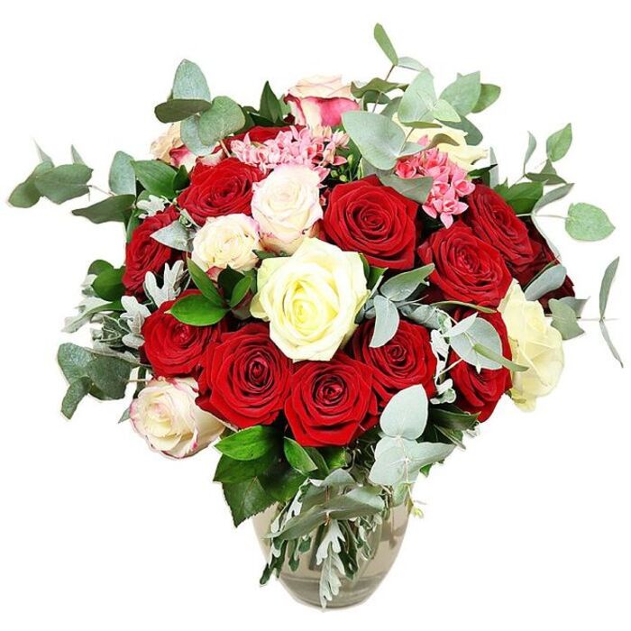 A sumptuous bouquet of roses stands proudly in a clear glass vase, set against a bright white background that lets every hue and texture shine. The arrangement is generously filled with deep red and vivid scarlet roses, their petals thick and velvety, some blooms cupped tightly while others open into large, layered spirals that suggest passion and devotion. Nestled among the reds are creamy white and warm ivory roses, as well as a few soft white blooms tipped with the palest pink, offering a gentle contrast that softens the overall look and adds a sense of tenderness. Scattered throughout are small clusters of bright pink filler flowers, likely mini carnations or similar petite blossoms, which thread delightful pops of colour and add a fine, lacy texture between the larger heads. Abundant eucalyptus in blue-green tones forms a fresh, modern halo around the roses, its round, silvery leaves curving gracefully outward and suggesting a cool, aromatic scent like you might notice stepping into a well-kept florist near Queensbury tube. Deeper green foliage from the rose stems fills the base and inner spaces, giving the bouquet a rounded, full silhouette and emphasising its carefully crafted structure. The transparent vase, with its slightly bulbous base and narrower neck, holds the stems neatly, revealing both their natural green hues and the clear water that keeps them vibrant. Created in the romantic red-and-white palette so popular for Valentine's Day or anniversary surprises across Queensbury, this bouquet visually conveys affection, elegance, and celebration, ready to become the centrepiece of a dining table or the highlight of a special doorstep delivery.