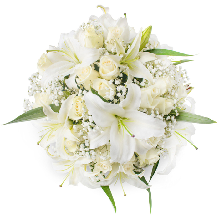 Captured in a top-down composition against a clean white backdrop, this round bouquet is an exercise in refined simplicity: several large white oriental-style lilies open with their trumpet-shaped petals, the centres showing pale green to soft yellow stamens that draw the eye inward. Around these focal lilies sit clusters of cream and ivory roses, mostly held as tight buds or gently unfurling blooms, their velvety layers building a plush, textural ground. Wisps of tiny white Baby's Breath (Gypsophila) are sprinkled between the larger blossoms, lending a delicate, cloud-like softness that offsets the lilies' bold shapes and the roses' dense petal structure. A few fresh green leaves emerge at the edges, providing a crisp, natural border that keeps the eye moving and reinforces the bouquet's circular geometry. The overall impression is of cool, subtle elegance - a softness in tone and a clarity in form - ideal for bridal bouquets, formal events, or a respectful gesture of condolence. The imagery will sit well in a Queensbury context, whether ordered for a wedding at a local hall near Queensbury tube station or sent as a thoughtful arrangement to neighbours in Kingsbury or Wembley; it reads as familiar and dependable, the kind of classic white bouquet a local florist would craft by hand with attention to proportion, scent balance, and lasting presentation.
