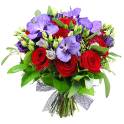 Close up in a Queensbury studio, this bouquet speaks of bold affection and careful craft. The plush crimson roses anchor the arrangement, their petals curling inward in velvety spirals that whisper romance, while the purple Vanda orchids rise like elegant wings, their wide petals carved with a delicate speckled pattern. Nestled between them, lisianthus in soft lavender and lilac provide a gentle counterpoint, some blooms still in bud to hint at new beginnings. A chorus of eucalyptus and broad green leaves creates a lush, natural backdrop, catching the light and giving the design depth and movement.

Every stem is hand gathered and tied at the base with a dark, almost black netted ribbon that adds texture and a contemporary edge. Fresh green buds pepper the arrangement, and tiny pale green filler blossoms weave through to finish the look with subtle sparkle. The mood is celebratory yet sophisticated, a luxury bouquet that suits anniversaries, significant birthdays, or as a dramatic centrepiece for a dinner party. For residents of Queensbury and the surrounding area, same-day delivery is available, bringing this striking piece from a trusted local florist to the doorstep with reliability and care.