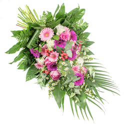 A refined funeral spray in a sweeping diagonal design stretches across a white background, evoking the quiet dignity of a farewell gathering in Queensbury. The arrangement begins at the upper left with a tightly bound cluster of stems, then opens outwards in a lush cascade of flowers and foliage that narrows gently toward the lower right. Large gerbera daisies, some in soft, powdery pink and others in bold fuchsia and deep magenta, create the main focal points, their daisy-like faces radiating warmth and affection. Between them nestle elegant pink roses, their spiralled petals unfurling in delicate layers that speak of devotion and cherished memories. White, ruffled blooms-likely small carnations or spray chrysanthemums-are scattered throughout, adding both texture and a luminous contrast against the richer colours. Delicate white daisy-style fillers thread through the spray like small stars, giving a light, playful touch that softens the formality of the tribute. Bright red hypericum berries, polished and rounded, punctuate the design and lend a subtle sense of depth. Supporting all of this is a rich mantle of greenery: broad, glossy leaves provide structure, feathery fern fronds introduce movement, and soft, silvery eucalyptus leaves bring cool tones and an imagined hint of fresh fragrance. Long, slender palm leaves arc gracefully from the lower right, reinforcing the arrangement's flowing line and adding a sense of gentle motion. Crafted with care by a local florist familiar with services held in and around Queensbury, this floral spray is intended as a heartfelt expression of sympathy, offering comfort and a beautiful tribute to a life remembered.