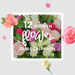 The photograph presents a lush, romantic bouquet that visually tells the story of a year-long rose subscription, imagined as one generous moment of bloom. At its centre, a tightly gathered dome of roses in blush pinks, creamy whites, soft lilacs, and vibrant fuchsias bursts forward, every bloom nestled closely into the next so the bouquet looks full and luxurious, like something just carried out of a cosy Queensbury florist on a quiet morning. The petals are velvety and layered, some loosely unfurling, others still cupped and shy, capturing the sense of ongoing surprise that comes with fresh flowers arriving month after month. Deep, polished green leaves cradle the flowers, peeking out between petals and giving the arrangement a natural structure, as if the stems were freshly snipped from a garden bordering Queensbury Park or a leafy street near Kingsbury. Gentle, creamy light falls from above, adding a soft sheen to the petals and making the pastel tones glow without harsh shadows. Around the main bouquet, scattered rose petals and a few separated blossoms drift across the frame, creating an impression of confetti and celebration, hinting at birthdays, anniversaries, or just-because moments celebrated across HA3. The background is neutral and uncluttered, allowing the roses to hold your full attention, like a centrepiece on a dining table after a special delivery. You can almost sense the fragrance-a mix of sweet, honeyed notes and that distinctive rose freshness-and imagine the calm pleasure of placing each new bouquet in a favourite vase, letting it brighten a Queensbury home through every season.