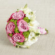 A luxurious bridal bouquet lies gently across a softly textured, light beige backdrop, the neutral tones giving centre stage to the flowers' vivid colours and refined details. The left and middle of the design are filled with lush pink roses, each bloom carefully opened to reveal a gradient of colour, moving from a calm, powdery blush at the core to bold fuchsia or magenta along the petal tips. Around and between these roses sit rounded tufts of lime-green button chrysanthemums, their compact, almost moss-like florets adding an intriguing tactile contrast and a lively, modern twist that feels perfectly at home for a contemporary Queensbury celebration. To the right, a cloud of white lisianthus softens the composition, with ruffled petals in shades of pure and creamy white and slim green buds that hint at blooms still to unfurl. This gentle transition from saturated pink and green into airy white gives the bouquet an almost painterly flow, as though light is slowly diffusing across the arrangement. The stems beneath are gathered with precision, wrapped tightly in a blush satin ribbon whose surface appears smooth and silky to the touch. Coiled over the top, rows of delicate white pearls trace elegant lines, creating a sense of heirloom jewellery woven into the handle. Set against the understated fabric, every petal, curve, and texture is clearly defined, showcasing the craftsmanship behind the design. It feels like the sort of bouquet chosen by a Queensbury couple marrying close to the station or in a nearby garden venue, capturing romance, freshness, and quiet sophistication in one timeless piece.