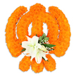 A meticulously crafted floral Khanda sits against a crisp white backdrop, its sacred outline rendered entirely from dense clusters of bright orange marigold blooms. From a careful distance you can make out the chakkar's circular form and the two crossed kirpans behind it, each edge defined by the compact, velvety texture of thousands of tiny marigold heads that catch the studio light and give the symbol a warm, almost glowing surface. At the geometric heart of the emblem, where the kirpans meet, a delicate bouquet of white lilies has been set like a quiet jewel: at least two fully open lilies with softly curved petals, subtle green and yellow stamens at their centres, and several smaller buds poised to unfurl. Sprays of tiny white filler flowers-baby's breath-nestle between the lilies and the marigolds, while glossy green foliage threads through the composition to add depth and a cool counterpoint to the exuberant orange. A faint drop shadow beneath the piece hints that this is a freestanding, hand-built tribute rather than a flat design, and the overall effect balances celebration with reverence. The scent imagined here moves from the earthy sweetness of marigold to the cool, soapy perfume of fresh lilies, creating a contemplative atmosphere suitable for Vaisakhi, Gurpurab or a communal offering at a local gurdwara. As a Queensbury neighbourhood florist would note, this piece feels both ceremonial and personal-a floral emblem that honours tradition while speaking to the careful craftsmanship of community makers in and around Queensbury and nearby Wembley.