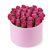 From a slightly elevated vantage, this luxurious arrangement centers dozens of freshly cut roses in a deep fuchsia and magenta palette. The blossoms are packed so tightly they form a lush, nearly sculptural dome that fills the circular hat box from edge to edge. The box itself is a pale pastel pink with a smooth, velvety matte finish, its cylindrical silhouette offering a refined contrast to the abundance of blooms. The petals unfold in soft spirals, their color shifting from lighter pinks toward the centers to richer berry tones along the outer rims, catching the light and revealing delicate variations in shade. Minimal greenery is visible, a deliberate choice to let the roses' satin-smooth surfaces and luminous color speak for themselves. The bouquet is photographed from a slightly elevated angle against a pristine white backdrop that heightens the sense of luxury and clarity, like a boutique display window catching the morning sun. You can almost feel the cool, velvet touch of each petal, the hush of fragrance in the air, and the promise of romance that such a gift conveys. This is a statement bouquet-perfect for marking a milestone, a grand birthday, or a moment of deep affection. In Queensbury and the surrounding corridors of Kingsbury and Edgware, local customers choose this style for its timeless elegance, reliable freshness, and impeccable presentation, with same-day or next-day delivery available through trusted local couriers.