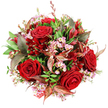 Captured from a top-down perspective against a bright white background, this bouquet appears as a sumptuous pool of reds, pinks, and greens, assembled with the kind of precision you might find in a trusted Queensbury flower shop. Rich, velvety red roses form the main focal points, their petals fully opened into layered swirls that convey romance and a sense of special occasion. Interspersed delicately among these statement blooms are soft pink waxflowers, their petite star-shaped petals and fine stems adding a dainty, almost lace-like quality that softens the drama of the roses. The arrangement is generously framed with fresh green foliage, from rounded, glossy leaves to more elongated shapes, creating a textured base that enhances the vivid colours and suggests freshly arranged stems ready for local delivery around Queensbury. In contrast to the bright greens, there are striking burgundy and bronze-toned leaves woven through the bouquet; their reddish-brown veins and subtly burnished surfaces add a refined, slightly autumnal elegance, reminiscent of seasonal walks past mature gardens in the area. Tucked among these leaves are smaller, darker red flowers-likely alstroemeria or a similar variety-that deepen the overall crimson palette and add gentle movement within the dome. The bouquet itself is artfully composed into a full, rounded shape with no visible gaps, presenting an impression of luxury and thoughtful design. Near the base, a sliver of red and white patterned tag or ribbon peeps out, hinting that this is a finished gift, perhaps on its way to a Queensbury doorstep for an anniversary dinner, romantic surprise, or festive celebration. The overall mood is passionate yet elegant, rich in texture and feeling.