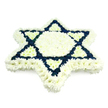 A large Star of David funeral tribute appears almost to hover against a crisp white background, its form composed entirely of fresh, tightly massed blooms. The six-pointed shape is clear and symmetrical, with a broad border of white chrysanthemums tracing every outer edge and filling the central hexagon, creating an impression of purity and gentle light. At the heart of the design, the iconic interlocking triangles of the Magen David are drawn in deep navy blue flowers, their velvety petals forming bold lines that cut cleanly through the softer white. These blue sections occupy the inner triangular bands, leaving the tips of the star and the central area serenely white, so the eye naturally follows the sacred geometry around. The arrangement is slightly domed rather than flat, suggesting careful layering and giving a sense of three-dimensional depth, as if the star has been softly cushioned on a bed of petals. While the studio-style backdrop is neutral, the tribute itself evokes the atmosphere of a quiet chapel or synagogue in Queensbury, perhaps after the cortege has arrived and everything has finally fallen silent. This is the kind of Jewish funeral piece chosen by families who want to honour a loved one's faith and heritage with dignity. The cool whites and deep blues, the smooth texture of packed blooms, and the flawless star outline together create a calm, respectful presence, suitable for delivery to memorial services, shiva houses, or cemeteries across Queensbury and the surrounding neighbourhoods.