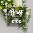 From Flower Delivery Queensbury, a pristine white-and-green floral spray sits gracefully against a pale grey backdrop, a mark of calm sophistication. The central focus is a cascade of pure white hydrangeas, their large, cloud-like clusters catching the eye near the top and center, paired with classic white roses in varying stages of bloom-some snugly furled, others fully opened-gliding through the composition. Delicate white lisianthus join on the left and lower-right, their bell-shaped forms tipped with faint green, adding gentle movement. Surrounding them, an abundance of greens-feathery ferns along the base and sides; soft, blue-green eucalyptus leaves; and darker, broader ruscus-create depth and a cool, refreshing contrast. The arrangement feels generous and lush, as if it could spill softly over the edges of a clear glass vase, though in the photo the blooms rest, serene, against the light backdrop, letting the textures talk. Overlaid in the center is a slim white border with white text: 'Florist' in an elegant script, then 'CHOICE' in clean uppercase sans-serif, below them 'SPRAY' separated by slender lines, and at the bottom a bold '?100', all with a subtle glow that lets the greens peep through. This is a Florist Choice Spray-a premium, ready-made tribute designed for sympathy, memorials, or refined home decor. The cool whites and greens evoke quiet respect, inviting same-day delivery across Queensbury for a tasteful, heartfelt gift that honours the moment and supports local family moments.